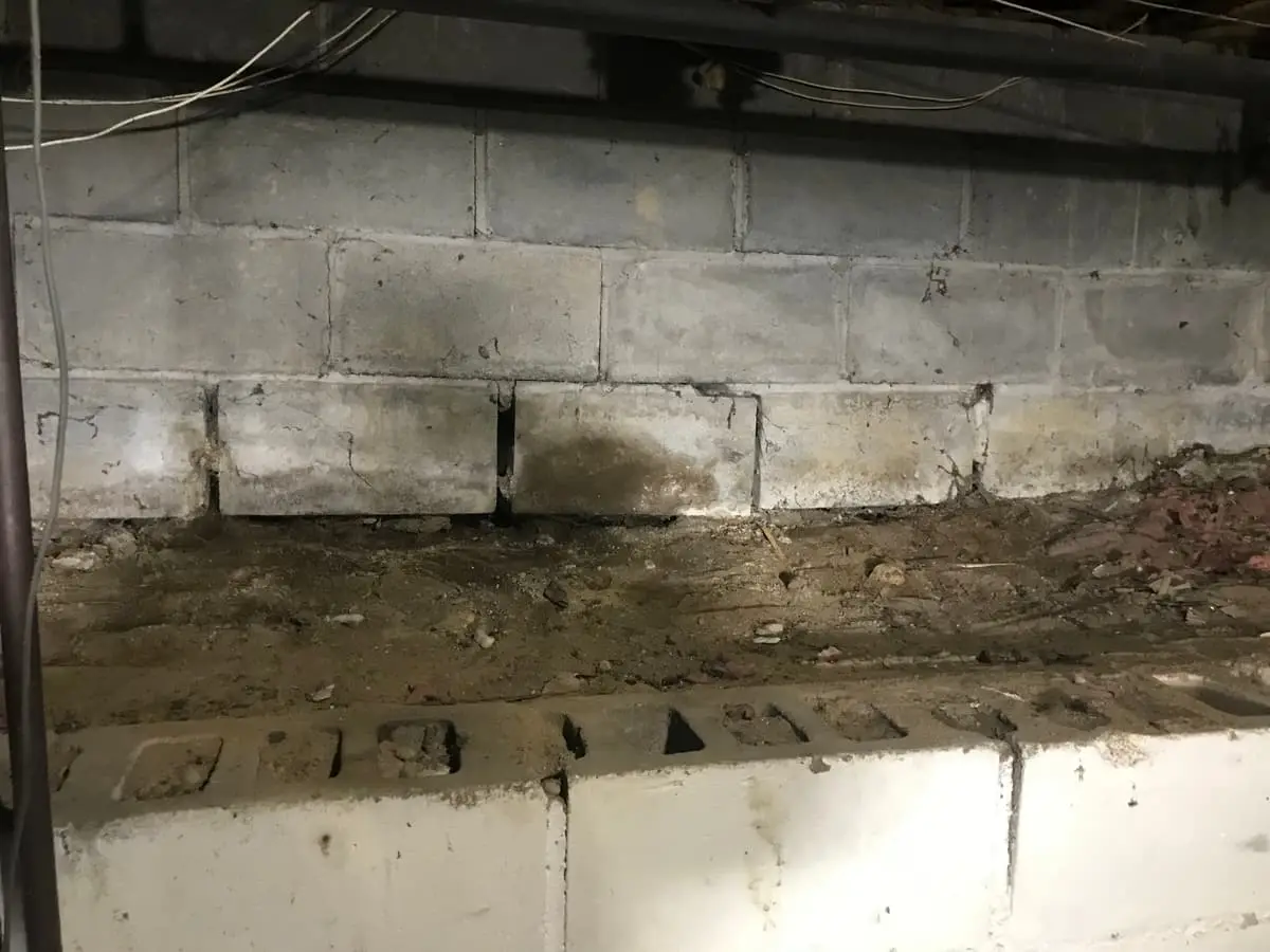 Selling a house with foundation problems in Shirley: crawl space with cracked and shifted block foundation