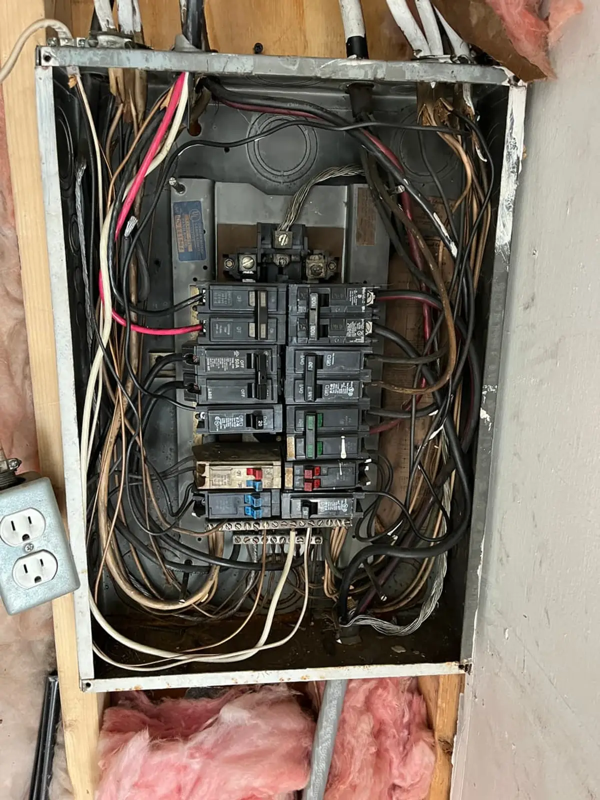 Selling a house with a reverse mortgage in Shirley: open electrical panel with a tangle of old wiring
