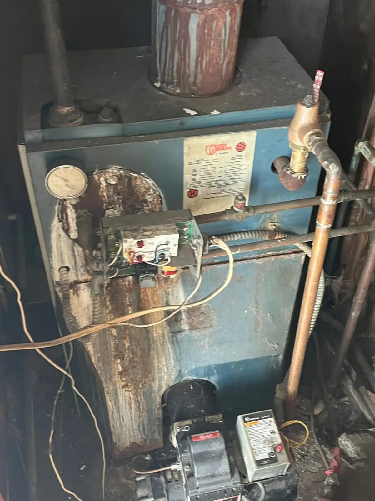 Selling a house after a life change in Shirley: rusted old boiler with exposed wiring