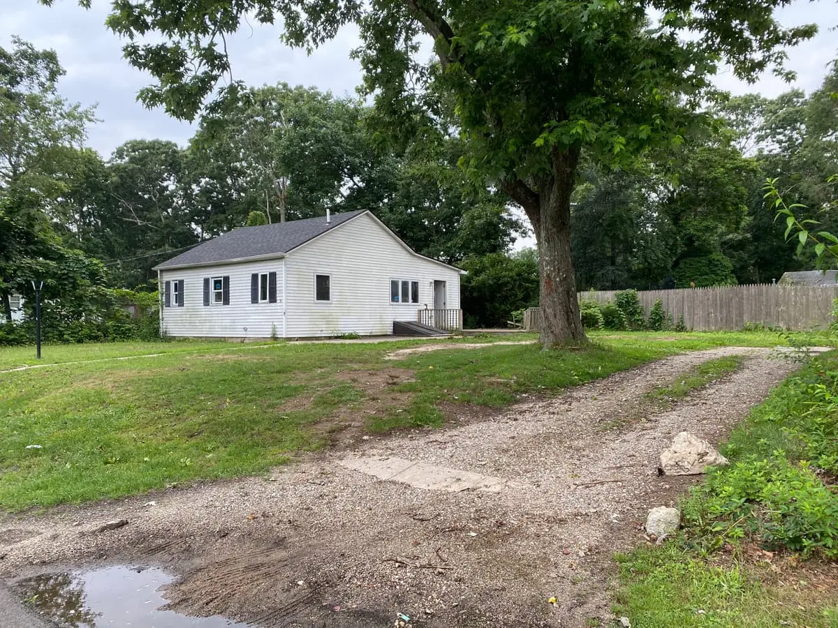Trying to stop a foreclosure in Shirley: small ranch set back behind a gravel driveway