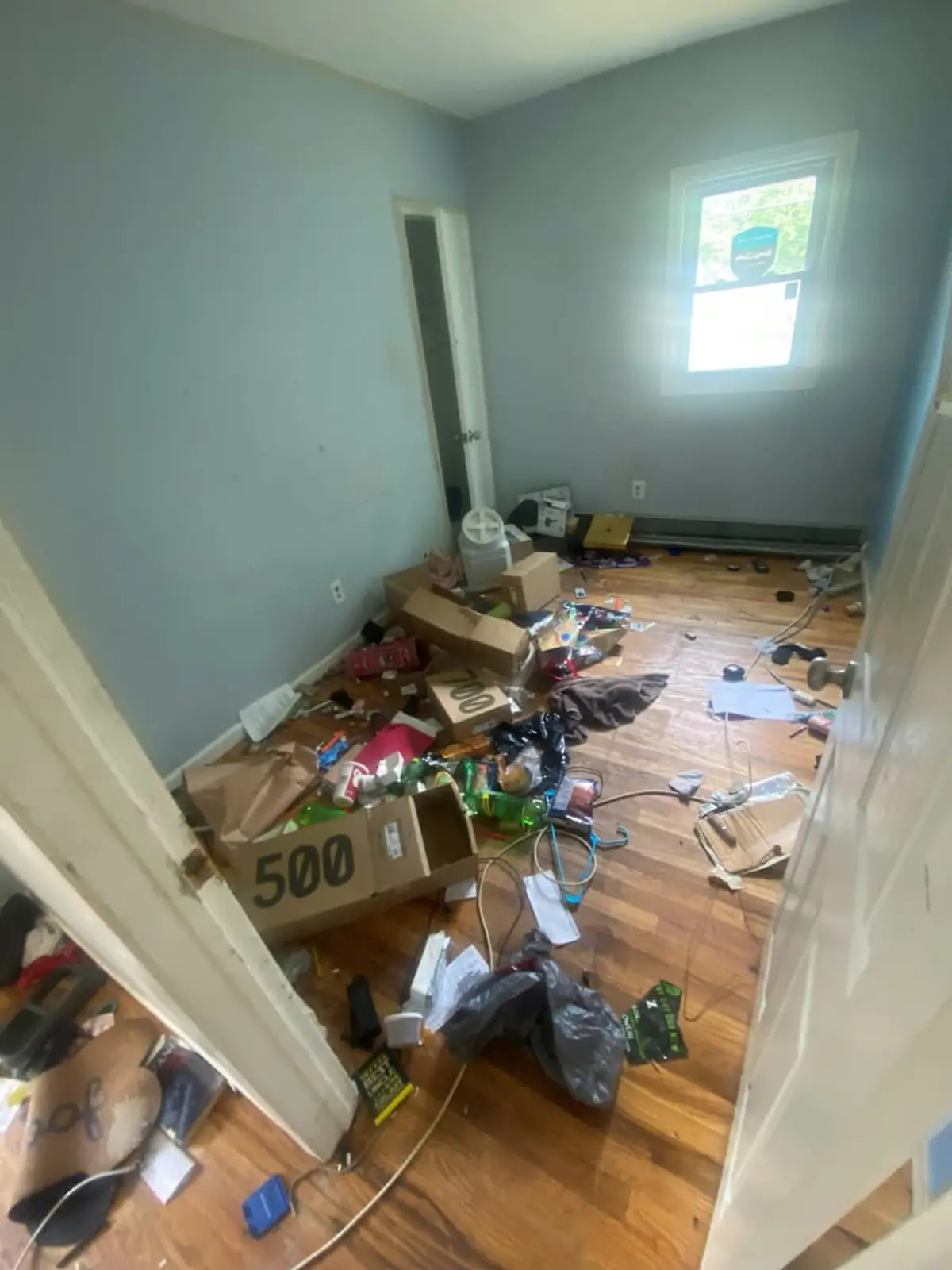 Selling a parent’s house after a move to care in Shirley: two story side entry with a red door and wood steps